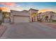 A single-story home with desert landscaping, a two car garage, and a covered entry at 15206 S 47Th St, Phoenix, AZ 85044