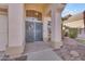 Charming front entrance with decorative blue door, transom window, and manicured landscaping at 15206 S 47Th St, Phoenix, AZ 85044