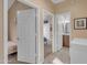 Hallway with multiple doorways leading to bedrooms and bathroom. Neutral paint and tile floors add to the appeal at 15206 S 47Th St, Phoenix, AZ 85044