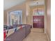 Inviting living room with high ceilings, large windows, tile floors, and comfortable seating at 15206 S 47Th St, Phoenix, AZ 85044