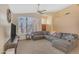 Bright living room featuring a large sectional sofa, neutral carpet, and ample natural light at 15206 S 47Th St, Phoenix, AZ 85044