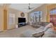 Spacious living room with large windows, plush seating, a ceiling fan, and tasteful decor at 15206 S 47Th St, Phoenix, AZ 85044