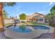 A refreshing pool is nestled in a backyard oasis complete with green grass, and desert landscaping at 15206 S 47Th St, Phoenix, AZ 85044