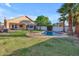 Beautiful backyard features a pool, lush green lawn, and mature palm trees at 15206 S 47Th St, Phoenix, AZ 85044