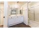 Bright bathroom featuring a vanity with marble countertops and a shower with sliding glass doors at 1523 W Glenn Dr, Phoenix, AZ 85021