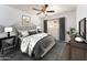 Comfortable bedroom with ceiling fan, window with curtains, and stylish furniture at 1523 W Glenn Dr, Phoenix, AZ 85021