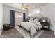 Cozy bedroom featuring a ceiling fan, window with curtains, and comfortable decor at 1523 W Glenn Dr, Phoenix, AZ 85021