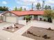 Home exterior with a red tile roof, desert landscaping, and a charming white fence at 1523 W Glenn Dr, Phoenix, AZ 85021