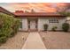 Inviting home facade with a walkway leading to the front door, and garden lighting at 1523 W Glenn Dr, Phoenix, AZ 85021