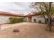 Charming home showcasing a desert landscaped front yard with a stone walkway at 1523 W Glenn Dr, Phoenix, AZ 85021