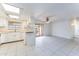 Bright kitchen with white cabinets and tile flooring, connecting to a spacious living area at 1523 W Glenn Dr, Phoenix, AZ 85021