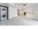 Open living area featuring a stacked washer-dryer, tile flooring and ample natural light at 1523 W Glenn Dr, Phoenix, AZ 85021