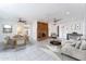 Open-concept living room with dining area, brick fireplace, and stylish furnishings at 1523 W Glenn Dr, Phoenix, AZ 85021