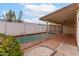 Backyard featuring a refreshing swimming pool with safety fence and covered patio area at 1523 W Glenn Dr, Phoenix, AZ 85021