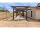 Shaded walkway and backyard featuring a low-maintenance desert landscape at 16010 N 47Th Dr, Glendale, AZ 85306