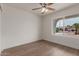 Bright bedroom with a ceiling fan, modern flooring and an inviting street view at 16010 N 47Th Dr, Glendale, AZ 85306