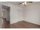Bright bedroom featuring a ceiling fan, roomy closet, and modern laminate flooring at 16010 N 47Th Dr, Glendale, AZ 85306