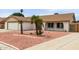 Exterior shot of a well-maintained single-story home with a two-car garage and desert landscaping at 16010 N 47Th Dr, Glendale, AZ 85306