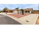 Exterior shot of a well-maintained single-story home with a two-car garage and desert landscaping at 16010 N 47Th Dr, Glendale, AZ 85306