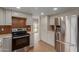 Open kitchen with stainless steel refrigerator, granite countertops, and warm backsplash at 16010 N 47Th Dr, Glendale, AZ 85306
