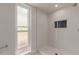 Contemporary shower with white tiled walls, window, and modern fixtures at 16010 N 47Th Dr, Glendale, AZ 85306