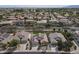 Expansive aerial view of a desert community with homes featuring solar panels and well-maintained landscaping at 18051 W Port Royale Ln, Surprise, AZ 85388