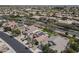 Aerial perspective of houses in a residential area, features a home with a pool, yard, and solar panels at 18051 W Port Royale Ln, Surprise, AZ 85388