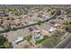 Aerial image showing a home with solar panels and backyard pool in a planned community at 18051 W Port Royale Ln, Surprise, AZ 85388