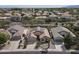 Wide aerial view of a desert community with homes featuring solar panels, well-maintained landscaping, and street view at 18051 W Port Royale Ln, Surprise, AZ 85388