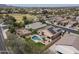 Aerial view of a home with a backyard pool and covered patio in a mature neighborhood at 18051 W Port Royale Ln, Surprise, AZ 85388