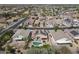 Wide aerial shot of homes in a neighborhood with backyard pools and solar panels at 18051 W Port Royale Ln, Surprise, AZ 85388