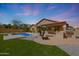 Beautiful backyard with a refreshing pool, built-in barbecue, and verdant lawn at 18051 W Port Royale Ln, Surprise, AZ 85388