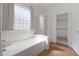 Bright bathroom featuring a large soaking tub and separate shower area at 18051 W Port Royale Ln, Surprise, AZ 85388