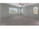 Spacious bedroom featuring plush carpet and large windows for natural light at 18051 W Port Royale Ln, Surprise, AZ 85388