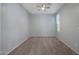 This is a spacious bedroom that features neutral carpet and light-colored walls and a ceiling fan at 18051 W Port Royale Ln, Surprise, AZ 85388