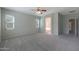Cozy bedroom with plush carpet, ceiling fan and view to a Primary bath at 18051 W Port Royale Ln, Surprise, AZ 85388