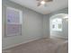 Cozy bedroom with carpet and archway providing ample natural light creating a peaceful retreat at 18051 W Port Royale Ln, Surprise, AZ 85388