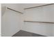 A clean closet with well-organized shelving and hanging rods for storage at 18051 W Port Royale Ln, Surprise, AZ 85388