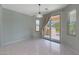 Bright dining room with tile floors and sliding glass doors to the backyard at 18051 W Port Royale Ln, Surprise, AZ 85388