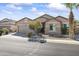Single-story home featuring a two-car garage and xeriscaped front yard at 18051 W Port Royale Ln, Surprise, AZ 85388