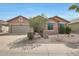 Charming single-story home featuring a low-maintenance desert landscaped front yard and attached two car garage at 18051 W Port Royale Ln, Surprise, AZ 85388