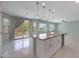 An open kitchen features a large island with bar seating, stainless steel appliances and backyard access at 18051 W Port Royale Ln, Surprise, AZ 85388