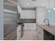 This is a modern kitchen with white cabinets, stainless steel appliances, and tiled backsplash at 18051 W Port Royale Ln, Surprise, AZ 85388