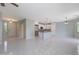 Open-concept living area with tile flooring, recessed lighting, and neutral paint providing a bright and airy space at 18051 W Port Royale Ln, Surprise, AZ 85388