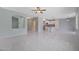 Bright, open living area showcasing the layout with tile floors and access to the kitchen at 18051 W Port Royale Ln, Surprise, AZ 85388