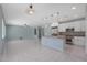This open concept living area leads into a modern kitchen with stainless steel appliances and backyard access at 18051 W Port Royale Ln, Surprise, AZ 85388