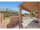 Covered patio features an outdoor grill, a view of the pool, and lush backyard landscaping at 18051 W Port Royale Ln, Surprise, AZ 85388