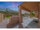 Covered patio with an outdoor kitchen, access to the pool and backyard at 18051 W Port Royale Ln, Surprise, AZ 85388