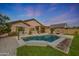Inviting pool featuring desert landscaping, a lush green lawn, and an outdoor patio at 18051 W Port Royale Ln, Surprise, AZ 85388