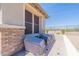 Patio area showcasing a brick privacy wall and shielded outdoor seating at 18159 W Piro St, Goodyear, AZ 85338